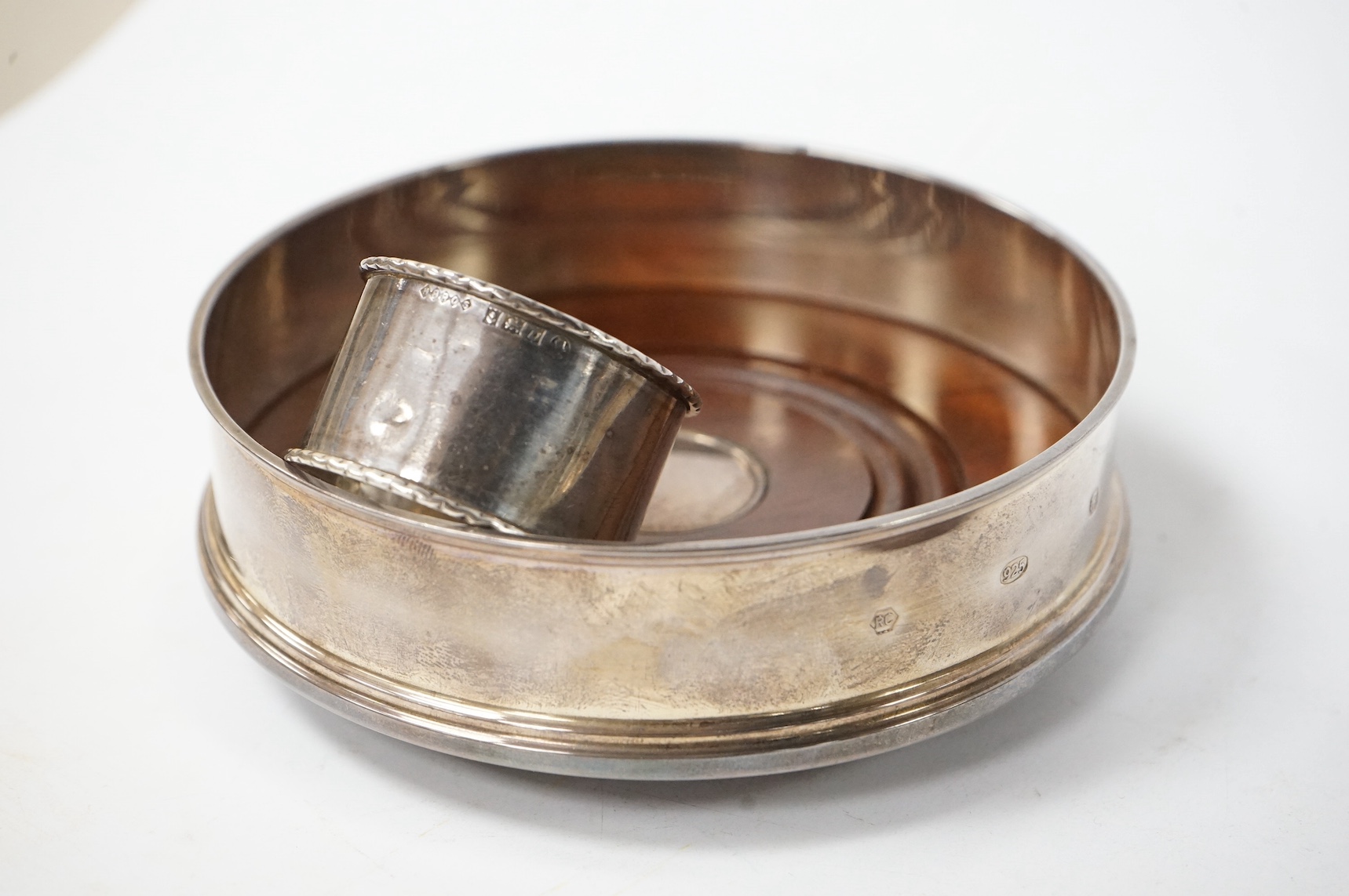Two modern silver mounted wine coasters, together with a silver napkin ring and a silver vesta case. Condition - poor to fair